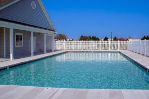 a swimming pool in front of a house at 13009 Bowline Ln 1 in Ocean City