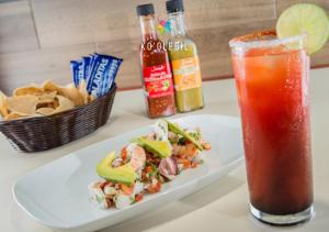 a plate of food and a drink on a table at KO'OLEBIL in Boca del cielo