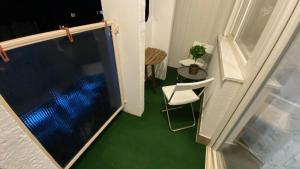 a view of a room with a chair and a window at Zrinyi Central Apartman with free parking in Nyíregyháza +26 photos
