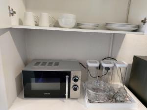 a kitchen counter with a microwave and a blender at Bliss on the bay in Richards Bay
