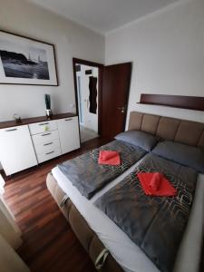 A bed or beds in a room at Wellness Apartman