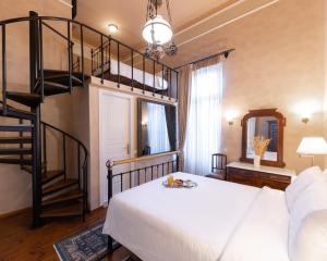 a bedroom with a bunk bed and a spiral staircase at Nafsimedon Hotel in Nafplio