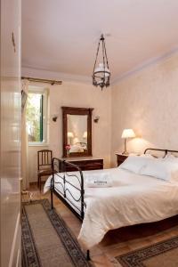 a bedroom with a large bed and a mirror at Nafsimedon Hotel in Nafplio