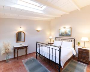 a bedroom with a bed and a mirror at Nafsimedon Hotel in Nafplio