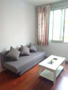 a living room with a couch and a coffee table at APTO PLAZA MERCED apartamentos in Málaga