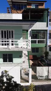 a green and white building with a balcony at Pousada Mar Verde in Florianópolis
