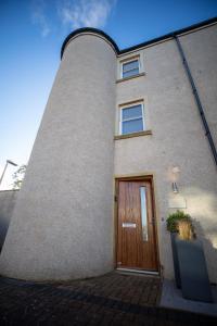 a brick building with a wooden door in front at No 1 The Turret in Kelso