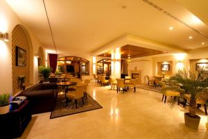 a living room with a couch and tables and chairs at Hotel Princess in Lednice