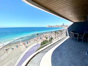 a view of the beach from the balcony of a resort at Exclusive Apartments on the first line of Benidorm Mar y Sol in Benidorm