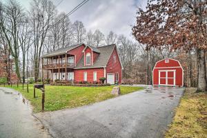 a red house with a red barn on a driveway at Dog-Friendly Family Home Steps to Norris Lake in Maynardville