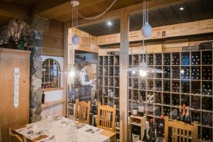 a man standing in front of a wine tasting room at Berghotel - Sexten in Sesto