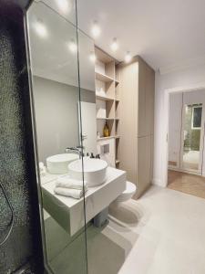 a bathroom with a sink and a glass shower at Selling Sunset Apartments in Timişoara +36 photos