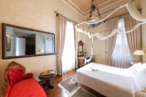 a bedroom with a bed and a mirror and a chair at Nafsimedon Hotel in Nafplio