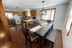 a kitchen with a wooden table and a dining room at Spacious, Sunny Lake House! Close to ski trails. in Windsor +36 photos