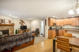 a kitchen and living room with a couch and a table at Vail Dreams in Vail