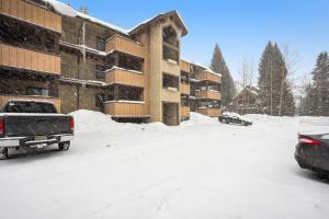 a snow covered parking lot in front of a building at Vail Dreams in Vail