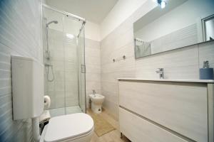 a bathroom with a toilet and a shower and a sink at B&B Clesio & Residence Buonconsiglio Apartments in Trento +33 photos