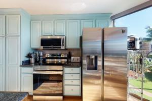 a kitchen with a stainless steel refrigerator and a microwave at Maui Sunset A317 in Kihei