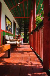 a walkway with benches and plants in a building at Finca La Playa Ecohotel - Experiencia Campestre - in Salento