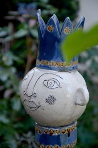 a vase with a face with a crown on its head at Pension Horn Bautzen in Bautzen