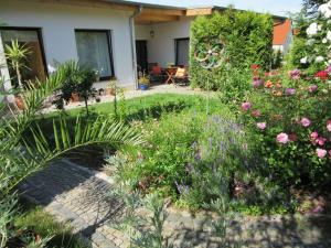 a garden with flowers and plants in front of a house at Pension Horn Bautzen in Bautzen