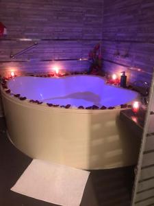 a large bath tub with lights in a room at Monterrico Hotel Perú in Lima