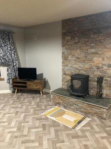 a living room with a fireplace and a stove at The Corner Apartment in Carlow