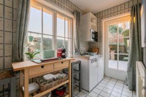 a kitchen with a counter and a sink and a window at Cosy Studio close to Bruxelles South Charleroi Airport in Courcelles
