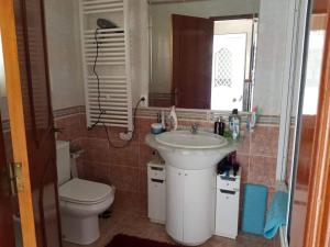 a bathroom with a sink and a toilet and a mirror at Altura Beach House in Altura