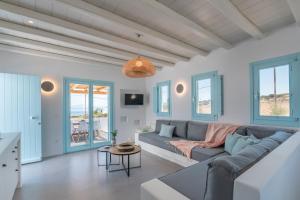 a living room with a couch and a table at Blue Harpist Villas in Koufonisia