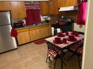 a kitchen with a table with red dishes on it at Nice 3 Bdr FREE Wine, Wi-fi and Parking in Milwaukee