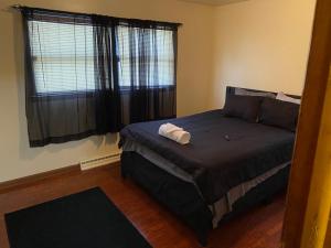 a bedroom with a large bed with a window at Nice 3 Bdr FREE Wine, Wi-fi and Parking in Milwaukee