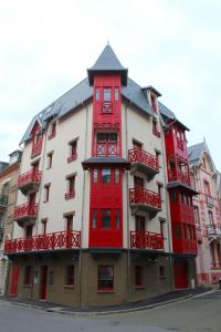 a red and white building with red balconies at Plage à 50m Appartement Rêves ensablés Villa Les Bains de Mers in Mers-les-Bains