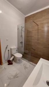 a bathroom with a toilet and a glass shower at Emplacement idéal in Tangier