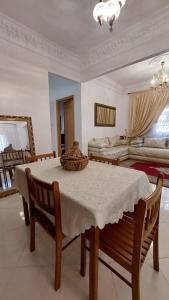 a dining room with a table and two beds at Emplacement idéal in Tangier