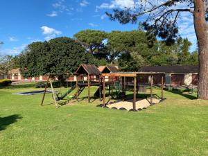 a playground with a swing set in a yard at Goose Valley Unit EE4 in Plettenberg Bay