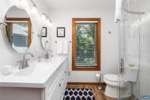 a bathroom with a sink and a toilet and a mirror at New! Luxury Mountain Top Retreat w/Carriage House in Lyndhurst