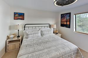 a white bedroom with a large bed and two lamps at Casa Azul in Western Sedona in Sedona