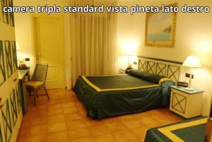 A bed or beds in a room at Hotel Club Sabbiadoro