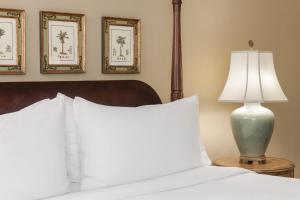 a white bed with two pillows on top of it at Indigo Inn in Charleston