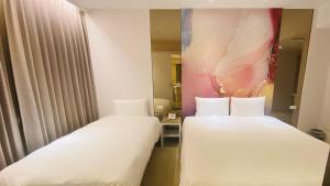 Voodi või voodid majutusasutuse Artinn藝築文旅-台北站前館 toas