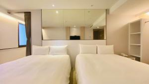 Voodi või voodid majutusasutuse Artinn藝築文旅-台北站前館 toas