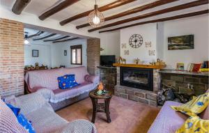 a living room with a couch and a fireplace at Nice Home In Puertollano With 4 Bedrooms, Outdoor Swimming Pool And Swimming Pool in Las Caserías