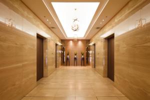 a hallway in a building with a ceiling at Kofu Kinenbi Hotel in Kofu