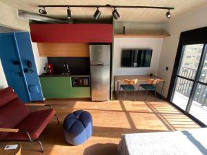 une cuisine avec un réfrigérateur en acier inoxydable et une table dans l'établissement 97 New studio next Paulista Av, fast wifi and balcony, à São Paulo