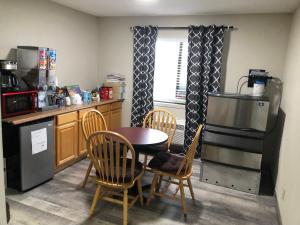 a kitchen with a table and chairs and a table and a stove at Budget Host Inn in Greenup