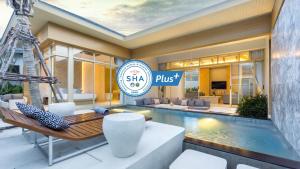 uma villa com piscina e uma placa que diz shka plus em Himmapana Villas - SHA Extra Plus em Praia de Kamala