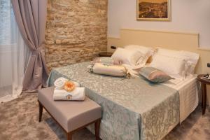 a bed room with a table and chairs at Heritage Hotel Antique Split in Split