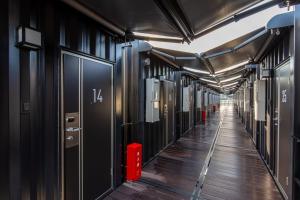 a long hallway with black walls and a long floor at HOTEL R9 The Yard Nakatsu in Nakatsu