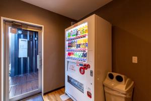 a white refrigerator in a corner of a room at HOTEL R9 The Yard Nakatsu in Nakatsu +17 photos